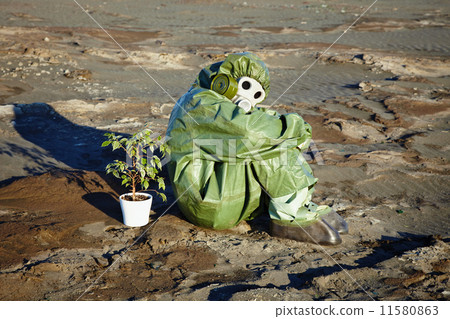 Man in chemical suit and houseplant in desert 11580863