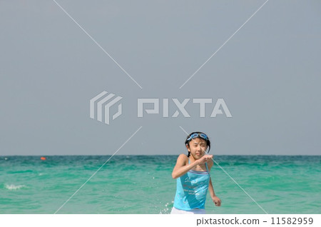 A girl running on the beach 11582959