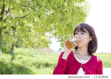 A woman who drinks tea at a park A woman who drinks tea at a park 11583602