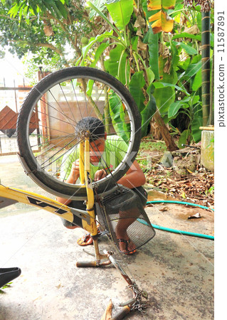 Man Repairs Bicycle 11587891