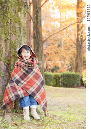 A child with autumn leaves and a smile 11595312