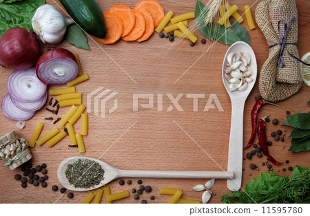 Frame made of spices and vegetables on a wooden table. 11595780
