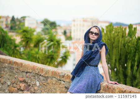 Elegant young woman in the Old town of Cannes 11597145