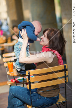 Happy young mother with her little son in a cafe Happy young mother with her little son in a cafe 11597310