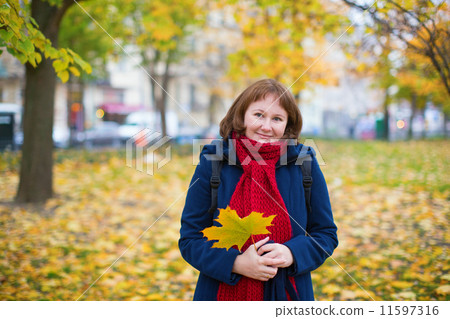 Cheerful girl in warm red scarf enjoying fall day 11597316