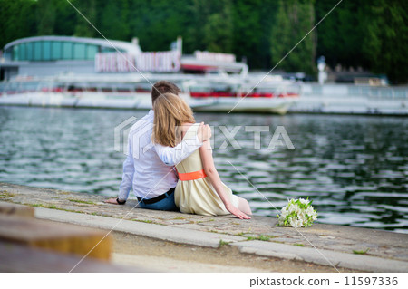 Newly-wed couple sitting on the Seine embankment 11597336