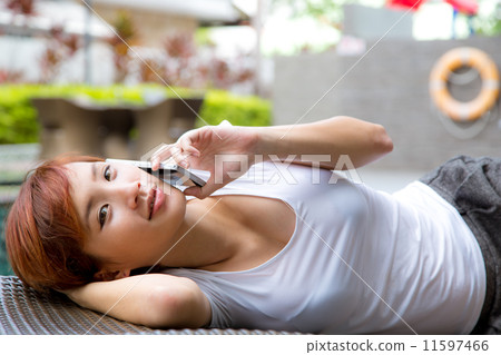 Young Asian woman using cellphone at resort, vacation and getaway 11597466