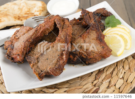 Grilled Tikka Lamb Chops with naan, lemon wedges and raita  11597646