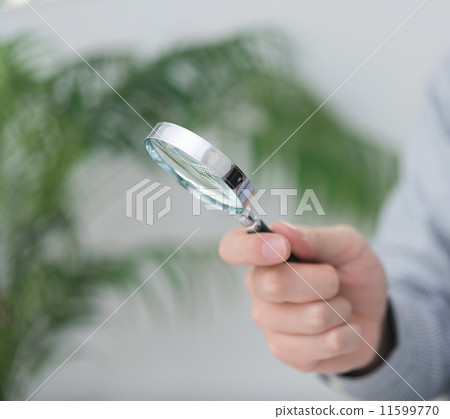 Hands observing plants with a magnifying glass Hands observing plants with a magnifying glass 11599770