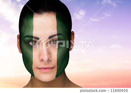 Composite image of beautiful brunette in nigeria facepaint 11600450