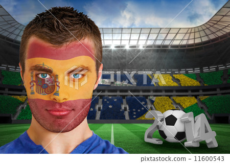 Composite image of serious young spain fan with facepaint 11600543