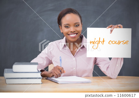 Happy teacher holding page showing night course Happy teacher holding page showing night course 11600617
