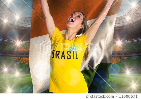 Composite image of pretty football fan in brasil t-shirt holding Composite image of pretty football fan in brasil t-shirt holding 11600671