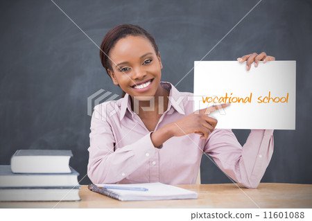 Happy teacher holding page showing vocational school 11601088