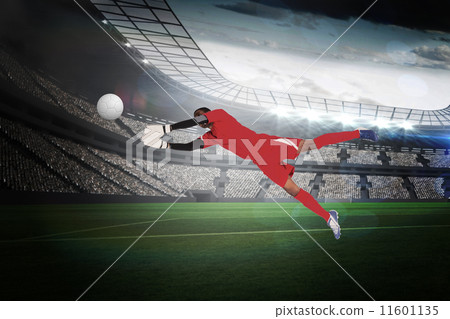 Composite image of goalkeeper in red making a save 11601135