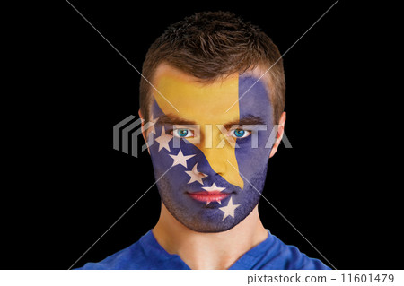 Composite image of serious young bosnian fan with facepaint 11601479