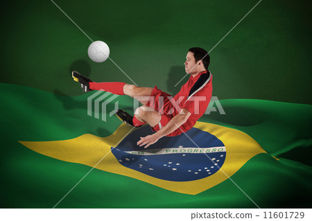 Composite image of football player in red kicking 11601729