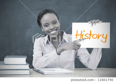 Happy teacher holding page showing history 11601740