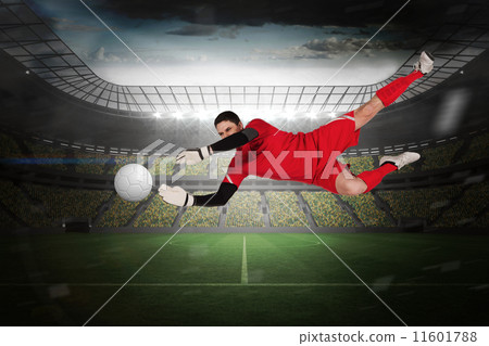 Composite image of fit goal keeper jumping up 11601788