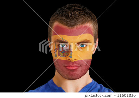 Composite image of serious young spain fan with facepaint 11601830