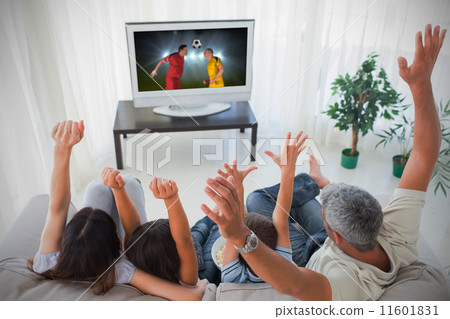 Family cheering and watching the world cup at home 11601831