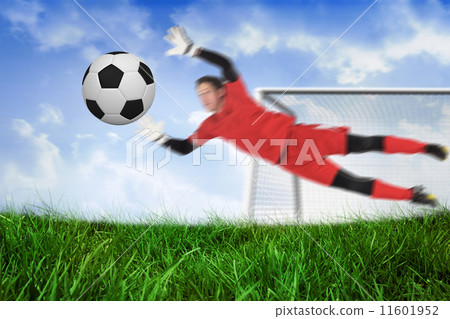 Composite image of fit goal keeper jumping up saving ball 11601952