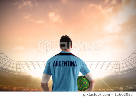 Composite image of argentina football player holding ball 11602083
