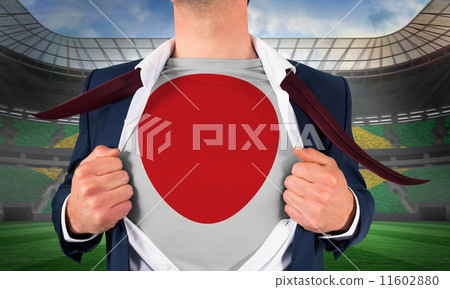 Composite image of businessman opening shirt to reveal japan fla Composite image of businessman opening shirt to reveal japan fla 11602880