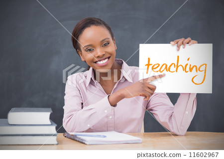 Happy teacher holding page showing teaching Happy teacher holding page showing teaching 11602967