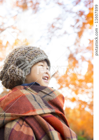 A child with autumn leaves and a smile 11607899