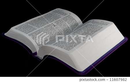 open Bible to psalm 118 isolated on a black background. 11607982
