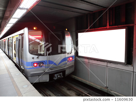 train at metro station with billboard 11609630