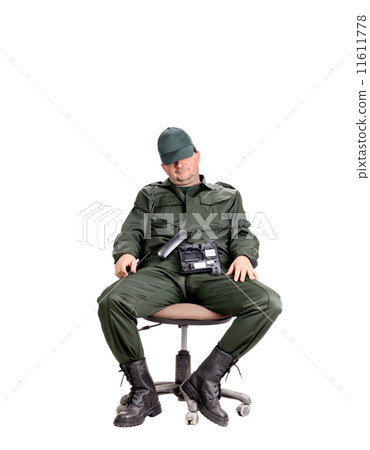 Man in workwear sitting with phone. 11611778