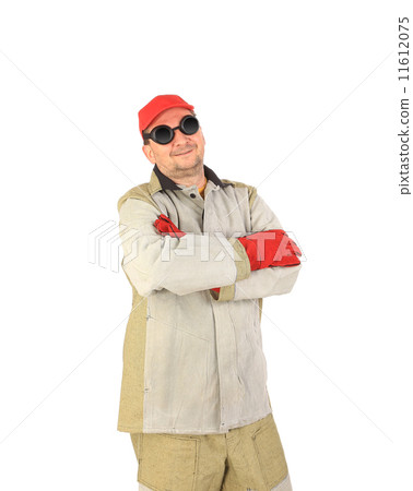 Smiling welder in glasses crosses arms. 11612075