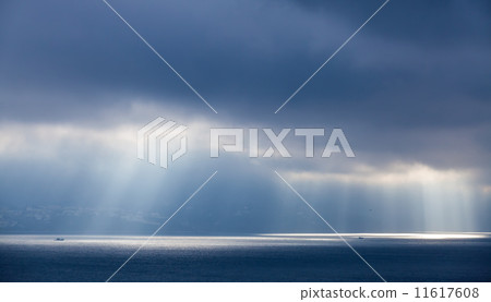Sunlight goes through dark clouds. Bay of Tangier, Morocco 11617608