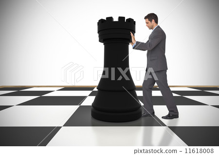 Composite image of businessman pushing chess piece Composite image of businessman pushing chess piece 11618008