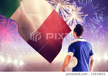 Composite image of italian handsome football player in blue jersey 11618052