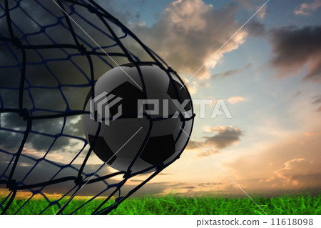 Composite image of football in back of the net 11618098