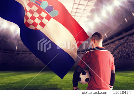 Composite image of goalkeeper in red holding the ball Composite image of goalkeeper in red holding the ball 11618434