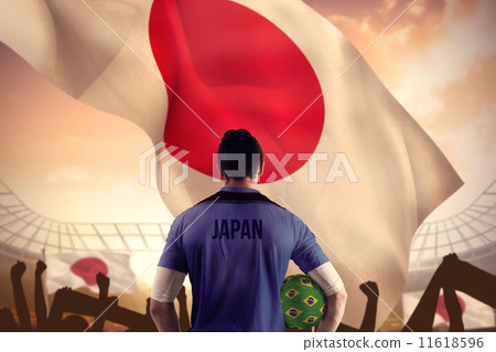 Composite image of japan football player holding ball Composite image of japan football player holding ball 11618596