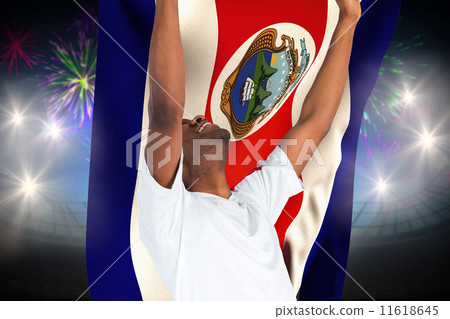 Composite image of excited handsome football fan cheering 11618645