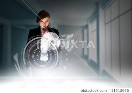 Composite image of redhead businesswoman using interactive desk Composite image of redhead businesswoman using interactive desk 11618656