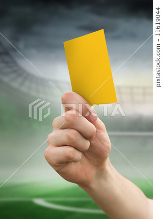 Composite image of hand holding up yellow card 11619044