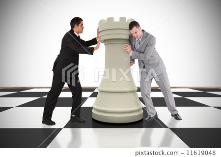 Composite image of business people pushing chess piece 11619048