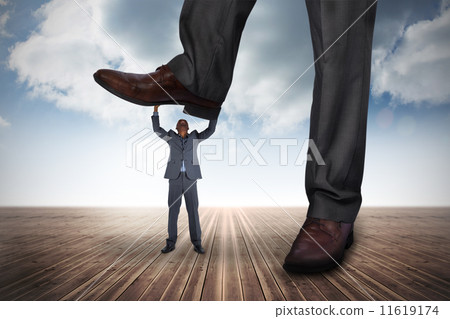 Composite image of businessman stepping on tiny businessman 11619174