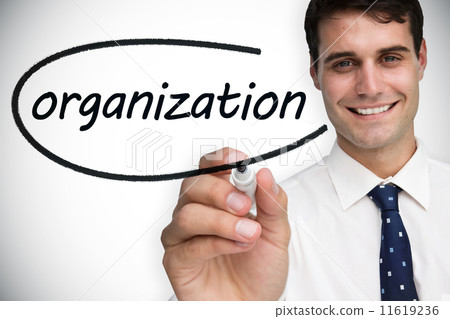 Businessman writing the word organization 11619236