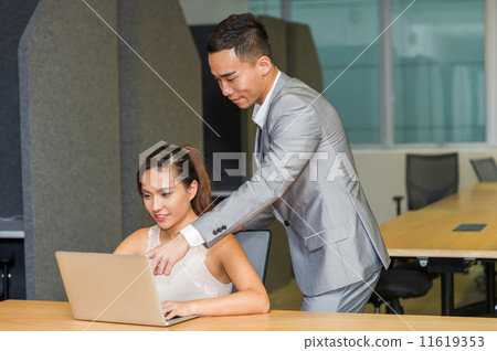 A responsible manager provides mentoring to his female co-worker to help her to be successful on job 11619353