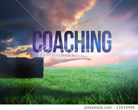 Businesswomans hand presenting the word coaching 11619498