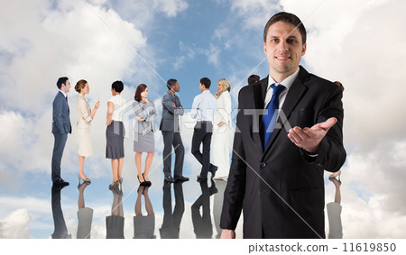 Composite image of handsome businessman holding hand out Composite image of handsome businessman holding hand out 11619850