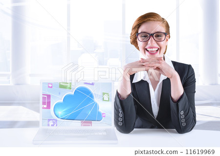 Composite image of redhead businesswoman sitting at desk 11619969
